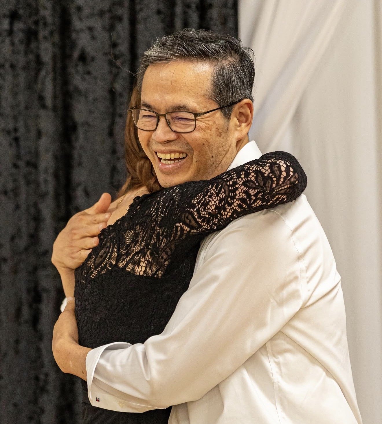 A couple sharing a joyful embrace after a dance lesson at Leva' Dance Club
